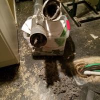Years of lint and debris clogging a dryer vent system.